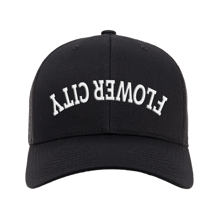Black trucker hat with white embroidered FLOWER CITY lettering on front
